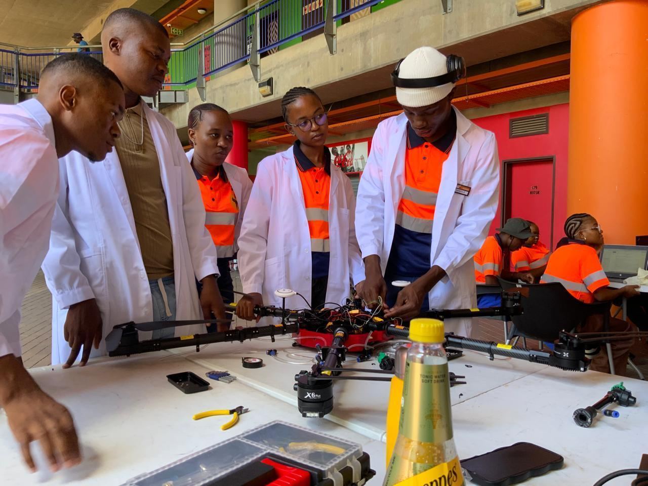 Young innovators building and testing a drone in a lab environment.