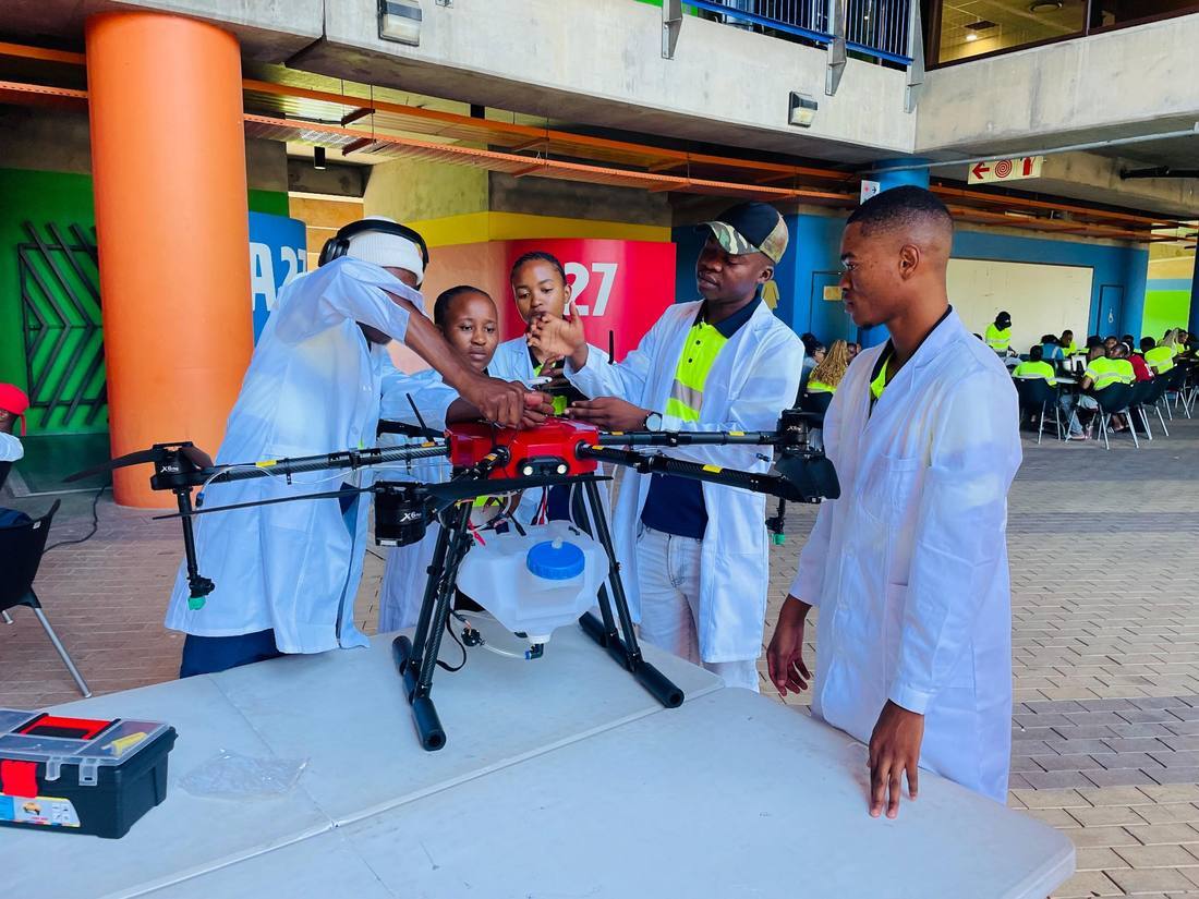 Rural youth and women working on a drone and engineering prototype in the JumpStart lab.